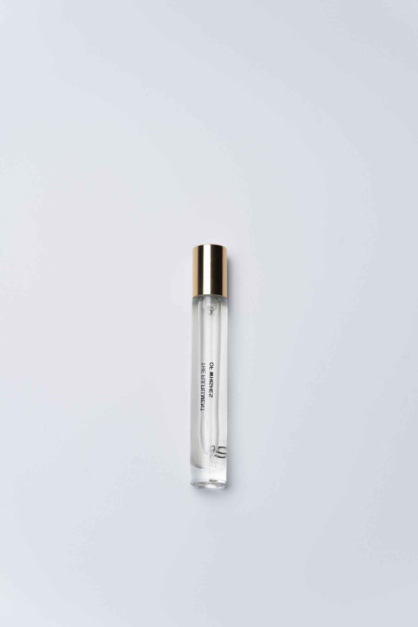 Clear cylindrical container with silver cap on a light gray background