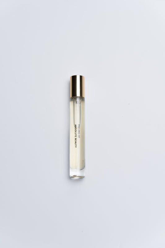 Small cylindrical container with a gold cap on a light gray background