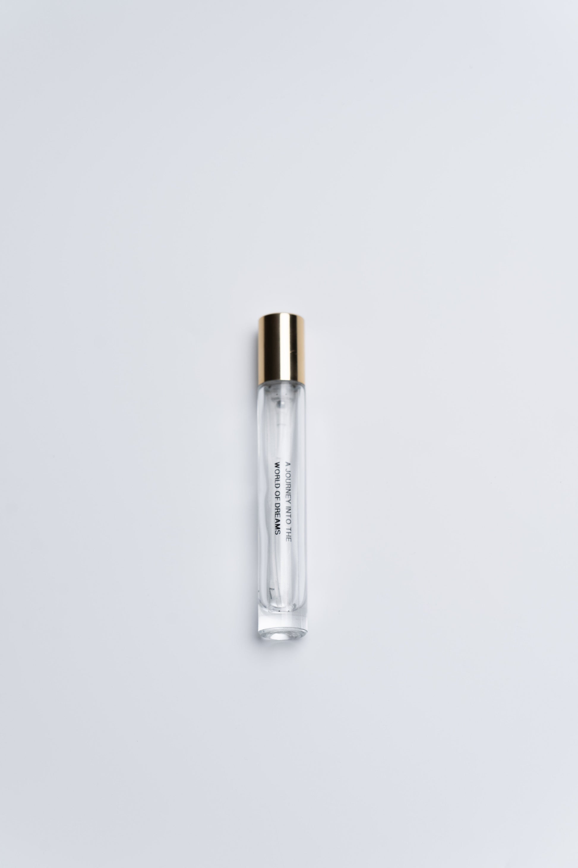 Clear plastic tube with gold cap on a white background