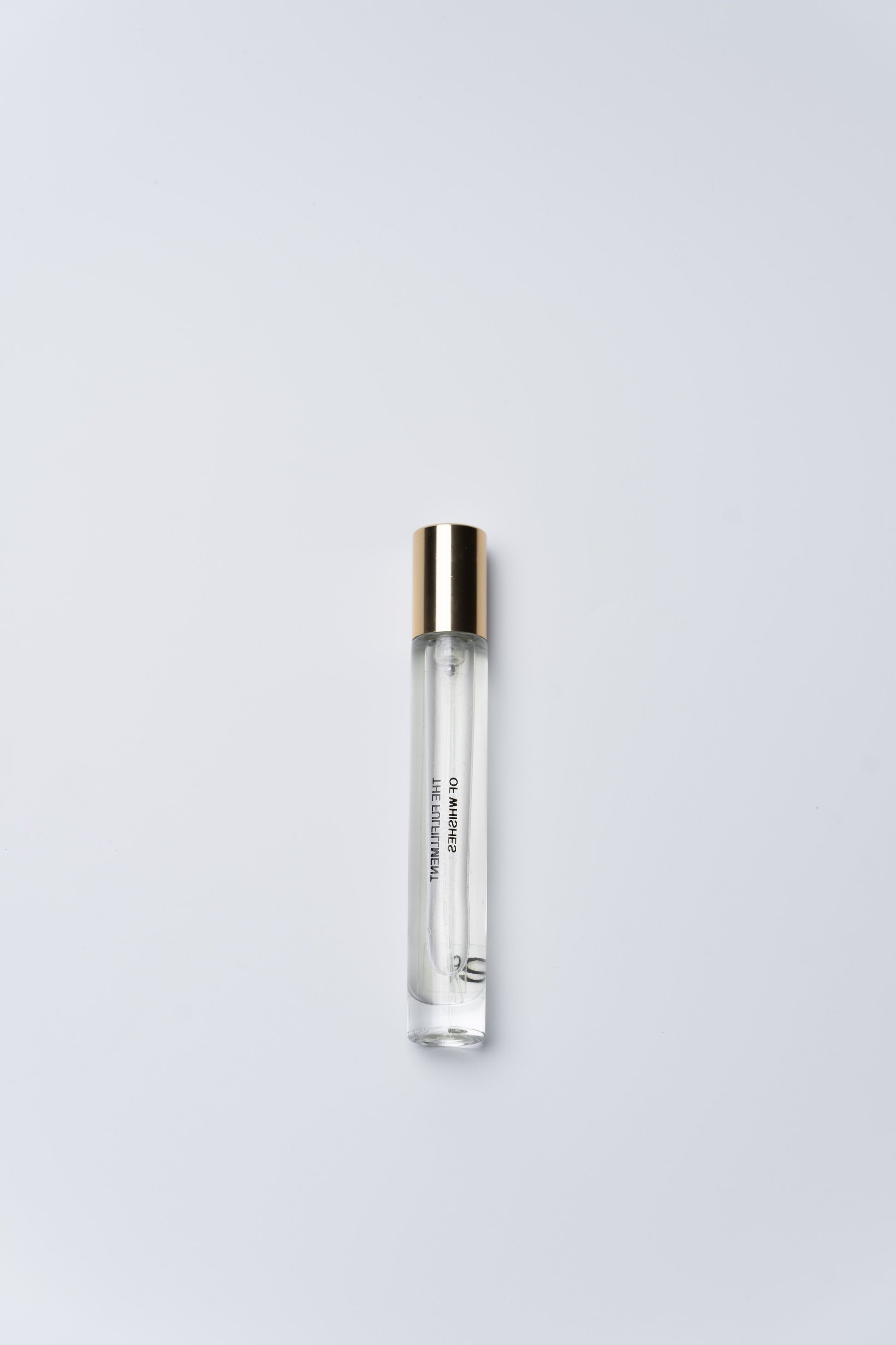 Clear cylindrical container with silver cap on a light gray background