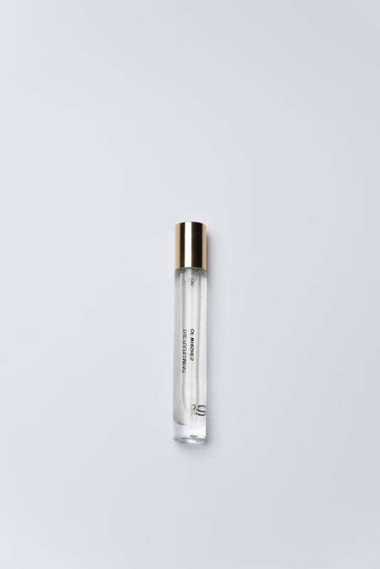 Clear cylindrical container with silver cap on a light gray background